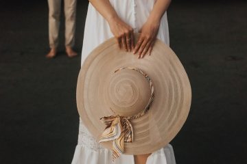 A girl holding a brown hat