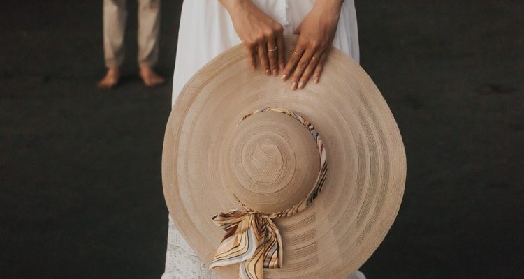 A girl holding a brown hat