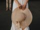 A girl holding a brown hat