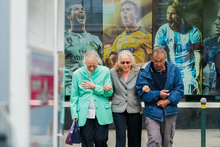 Elderly people walking while holding hands in hands