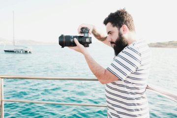 Man Taking Photos on a Yacht