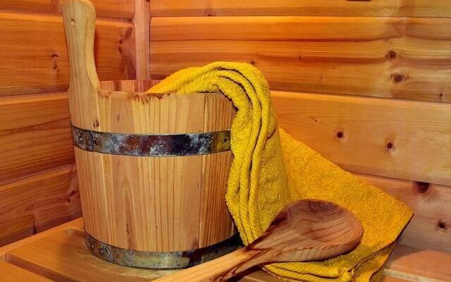 Wooden bucket and yellow towel for wellness