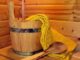 Wooden bucket and yellow towel for wellness